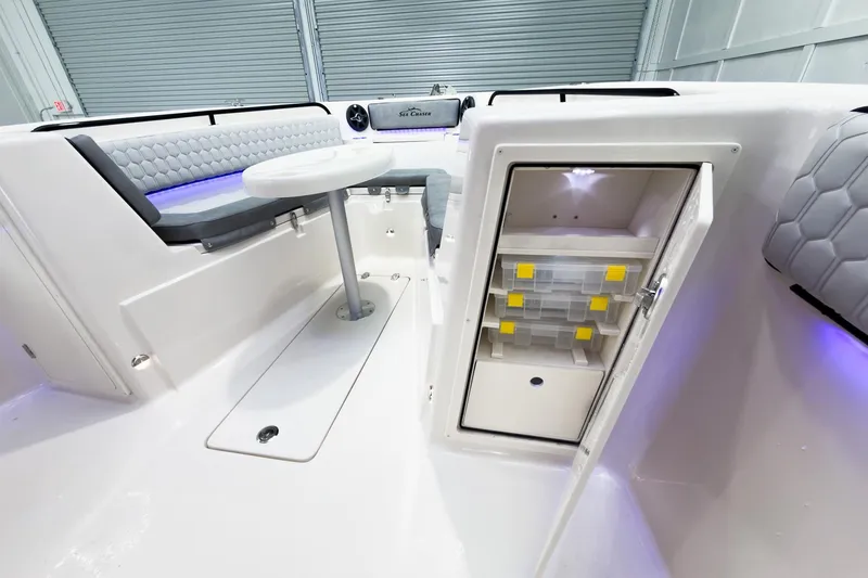 Slide: The Image of 2026 Sea Chaser 27 HFC CC boat interior with seating, table, and storage compartment. - 34