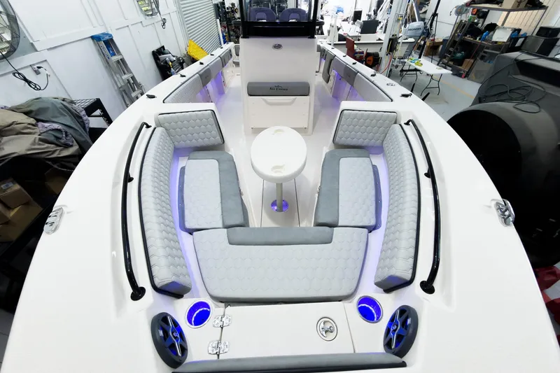 Slide: The Image of 2026 Sea Chaser 27 HFC CC boat interior with cushioned seating and modern design. - 36