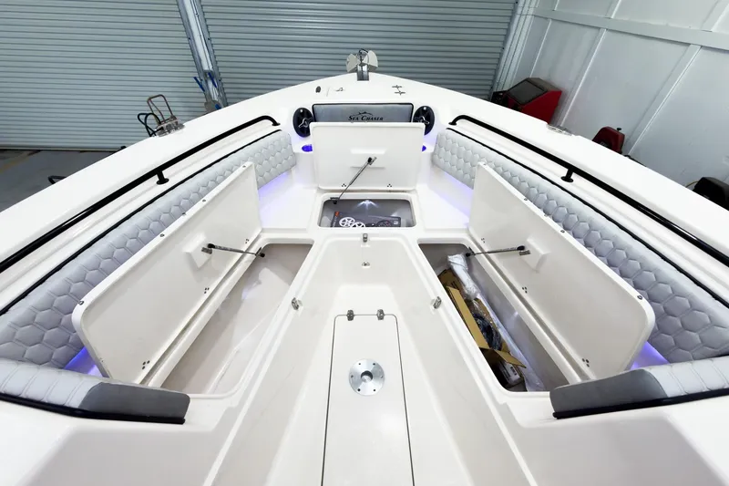 Slide: The Image of 2026 Sea Chaser 27 HFC CC boat interior with open storage compartments and cushioned seating. - 39