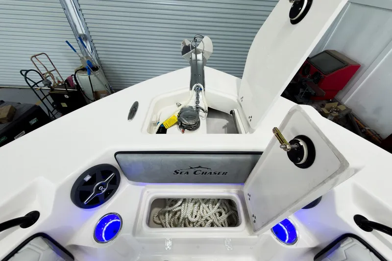 Slide: The Image of 2026 Sea Chaser 27 HFC CC boat deck with storage compartments and anchor. - 40