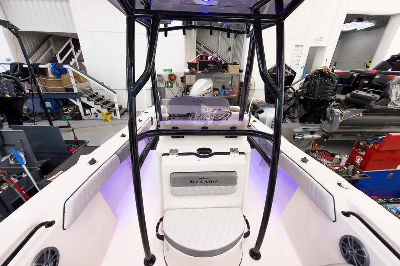Slide: The Image of 2026 Sea Chaser 22 HFC boat interior in a workshop, featuring modern design and equipment. - 11
