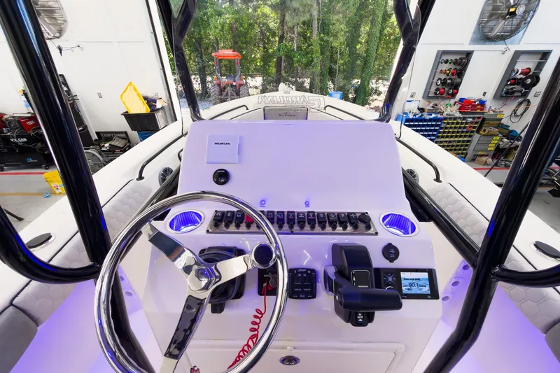 Slide: The Image of 2026 Sea Chaser 22 HFC boat dashboard with steering wheel and control panel. - 17