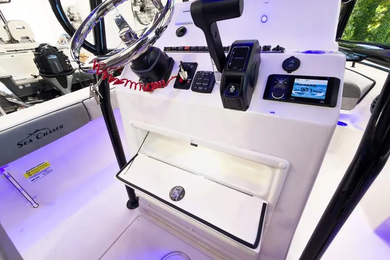 Slide: The Image of 2026 Sea Chaser 22 HFC boat console with steering wheel and control panel. - 19