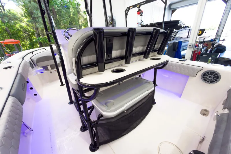 Slide: The Image of 2026 Sea Chaser 22 HFC boat interior with seating, rod holders, and storage. - 23