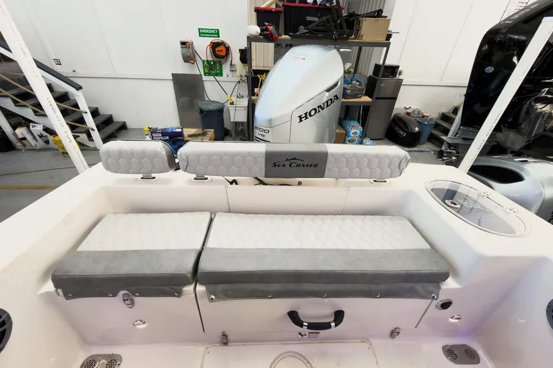 Slide: The Image of 2026 Sea Chaser 22 HFC boat interior with Honda engine in workshop setting. - 24