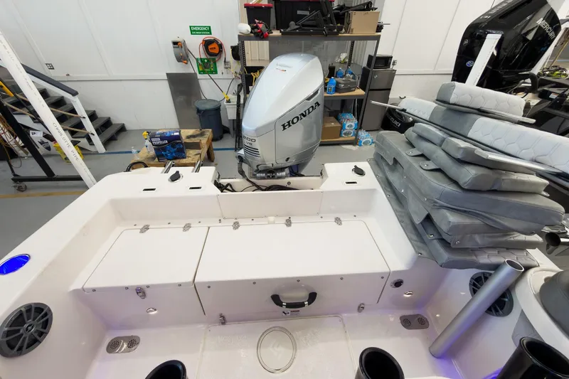 Slide: The Image of 2026 Sea Chaser 22 HFC boat interior with Honda engine in workshop setting. - 25
