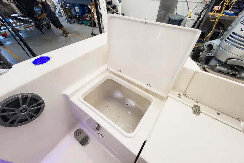 Slide: The Image of 2026 Sea Chaser 22 HFC boat interior with open storage compartment in a workshop. - 26