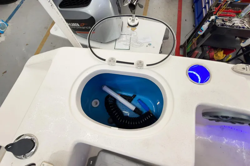Slide: The Image of Livewell on 2026 Sea Chaser 22 HFC boat, featuring blue interior and coiled hose. - 27
