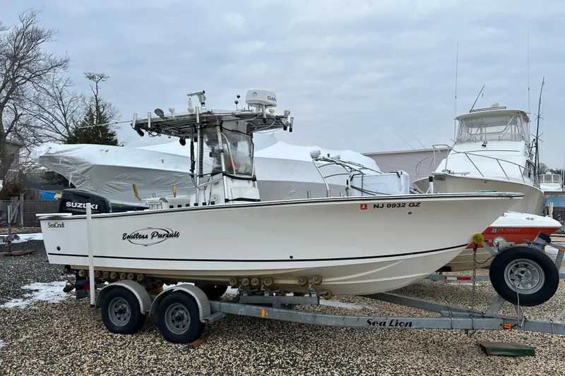 Slide: The Image of 2007 SeaCraft SC 23 Classic boat on trailer, parked outdoors. - 15