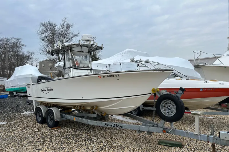 Slide: The Image of 2007 SeaCraft SC 23 Classic boat on trailer in a boatyard. - 17
