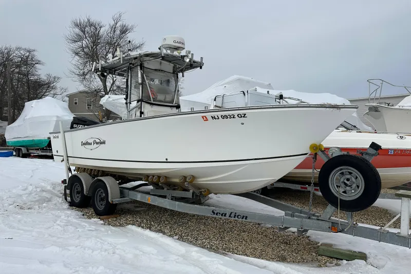 Slide: The Image of 2007 SeaCraft SC 23 Classic fishing boat with rods and Suzuki engine at night. - 2