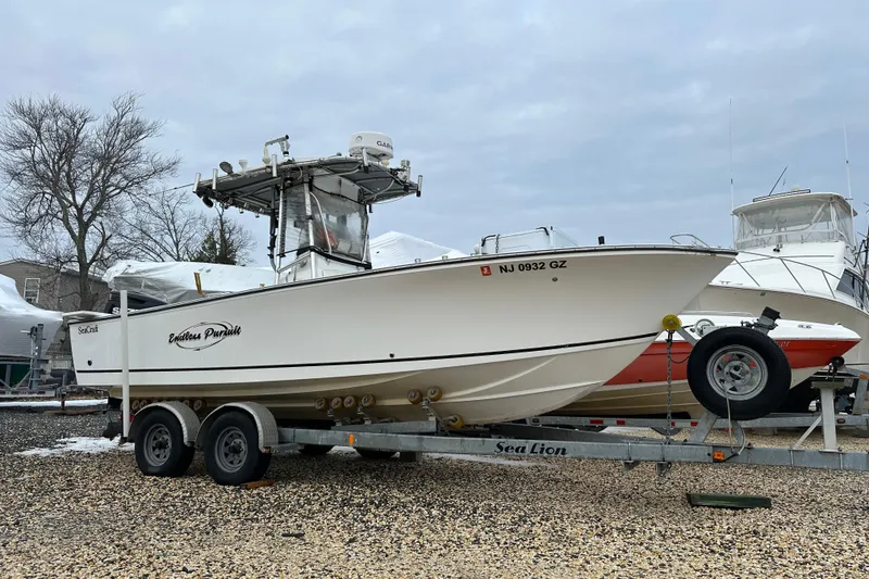 Slide: The Image of 2007 SeaCraft SC 23 Classic boat on trailer, parked outdoors. - 22