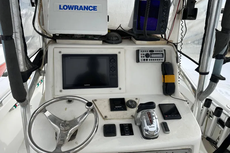 Slide: The Image of 2007 SeaCraft SC 23 Classic boat on water with fishing gear and outboard motor. - 4