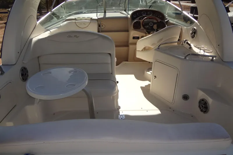 Slide: The Image of 2002 Sea Ray Sundancer 280 interior with seating, table, and helm. - 13
