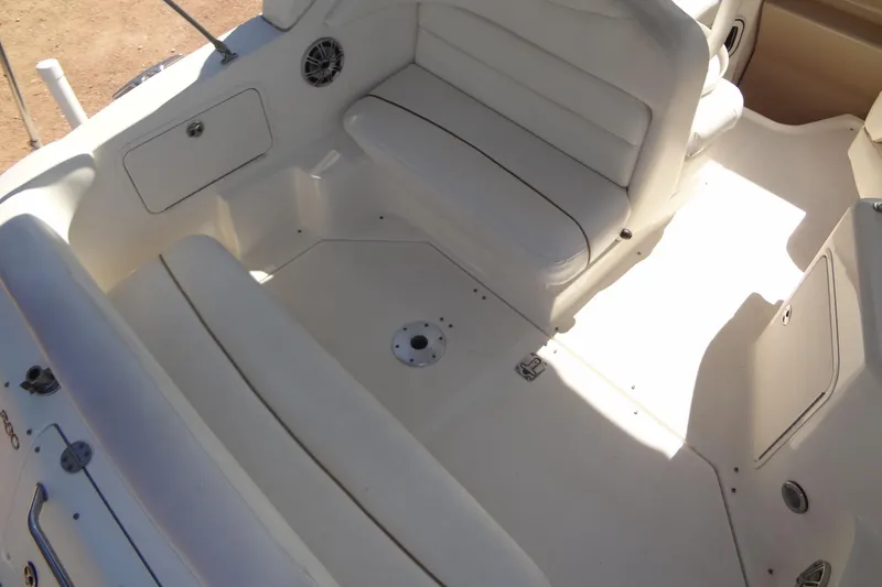 Slide: The Image of 2002 Sea Ray Sundancer 280 boat interior with white seating and storage compartments. - 15