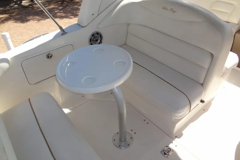 Slide: The Image of 2002 Sea Ray Sundancer 280 interior with white seating and round table. - 16