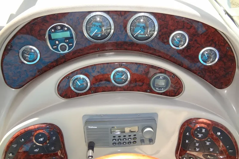 Slide: The Image of Dashboard of a 2002 Sea Ray Sundancer 280 boat with gauges and controls. - 24