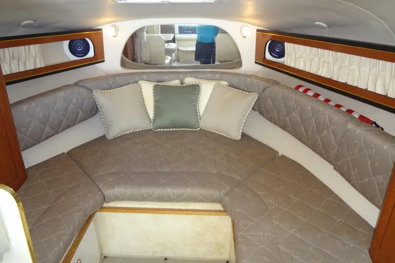Slide: The Image of Interior of 2002 Sea Ray Sundancer 280 with cushioned seating and decorative pillows. - 29