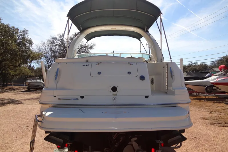 Slide: The Image of 2002 Sea Ray Sundancer 280 boat, rear view, parked outdoors under clear sky. - 3