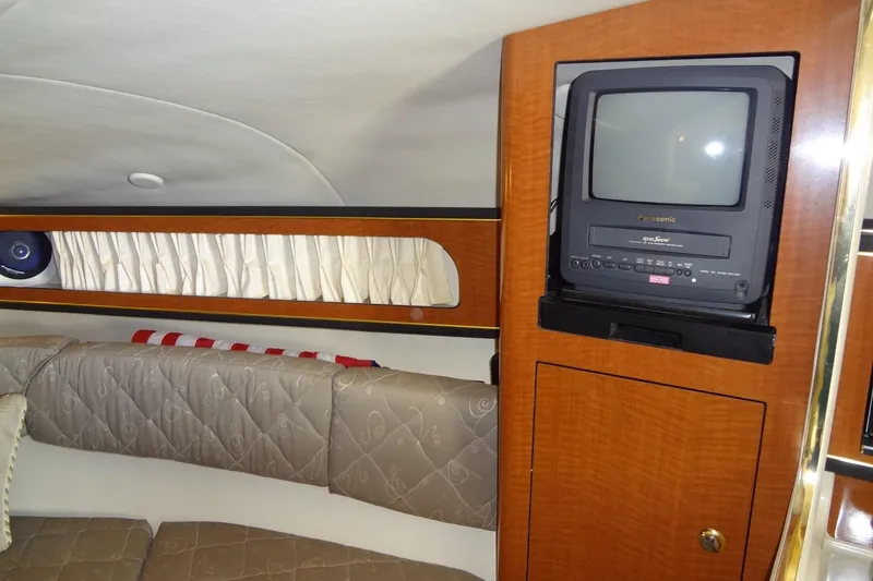 Slide: The Image of Interior of 2002 Sea Ray Sundancer 280 with TV and cushioned seating. - 32