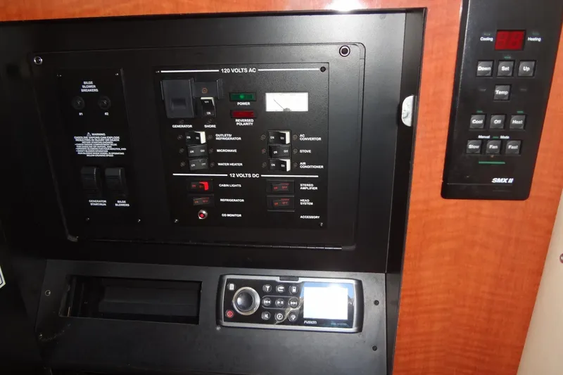 Slide: The Image of Control panel of a 2002 Sea Ray Sundancer 280 boat, featuring electrical switches and controls. - 37