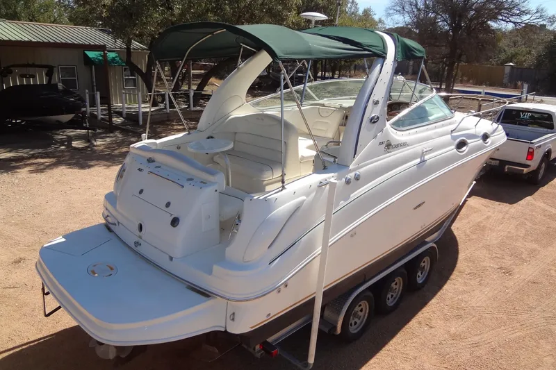 Slide: The Image of 2002 Sea Ray Sundancer 280 boat on trailer, white exterior, green canopy, parked outdoors. - 4