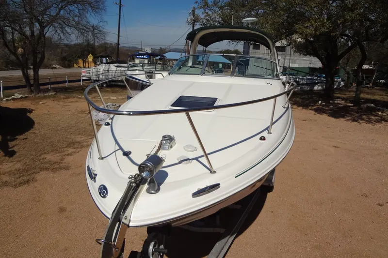 Slide: The Image of 2002 Sea Ray Sundancer 280 boat on trailer, parked outdoors under clear sky. - 9