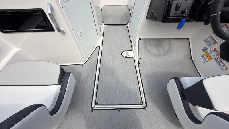 Slide: The Image of Interior of a Yamaha SX195 boat with gray flooring and white seats. - 22