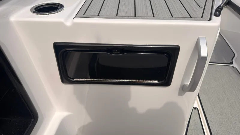 Slide: The Image of Close-up of a white boat deck with a black compartment and silver handle. - 18