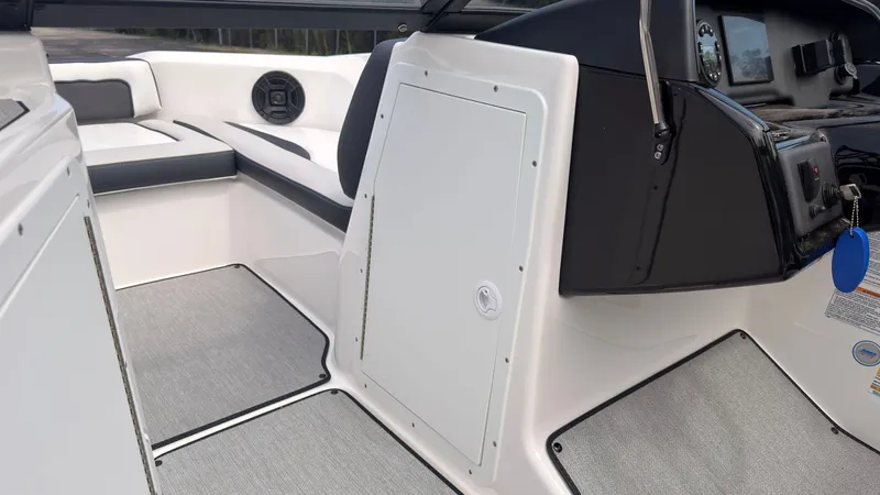 Slide: The Image of Interior of a Yamaha SX195 boat with gray carpeting and black accents. - 32