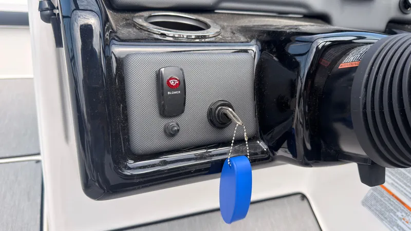 Slide: The Image of Close-up of a boat switch panel with a blue key fob and a button. - 26