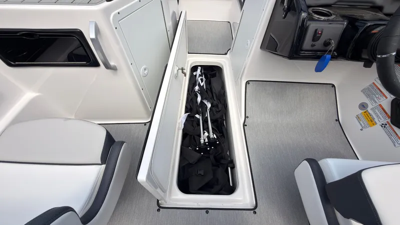 Slide: The Image of The image shows the storage compartment of a 2026 Yamaha SX195 boat with equipment. - 23