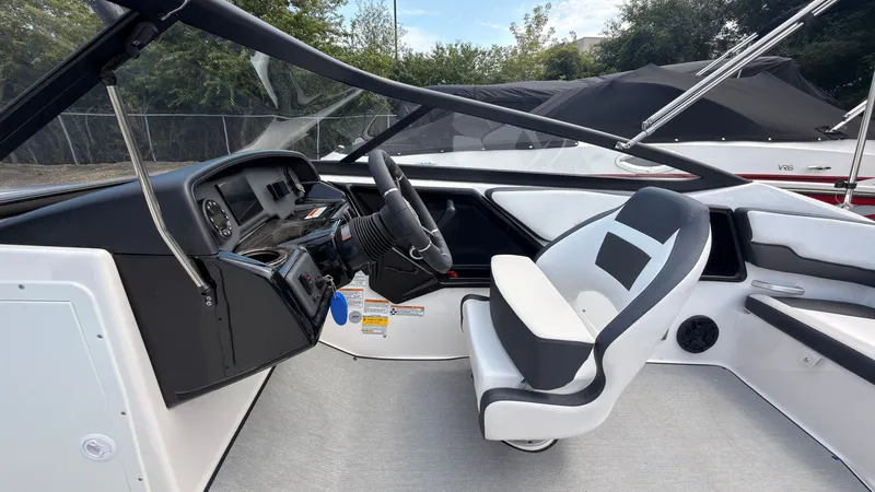 Slide: The Image of The image shows the cockpit of a Yamaha SX195 boat with a modern helm and comfortable seat. - 24
