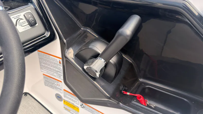 Slide: The Image of Close-up of the throttle lever on a Yamaha SX195 boat, surrounded by controls and warning labels. - 30