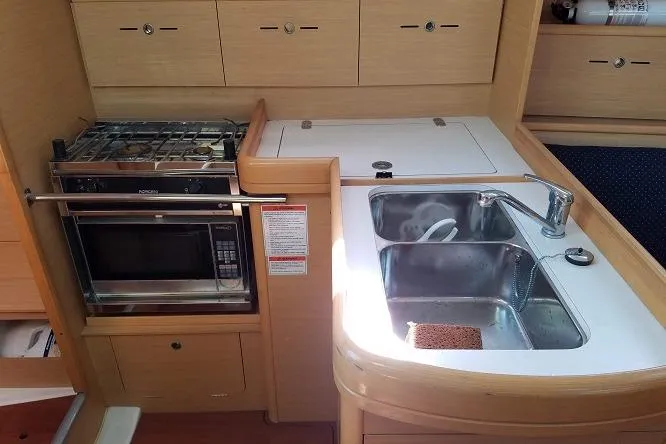 Slide: The Image of Compact kitchen area in a 2010 Beneteau First 36.7 yacht, featuring a sink and microwave. - 4