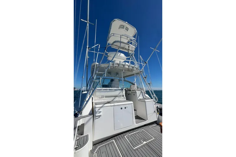 Slide: The Image of 2005 Rampage 38 Express boat with tower, viewed from the rear on open water. - 15