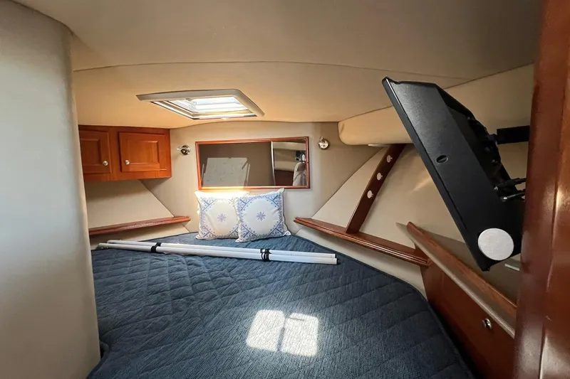Slide: The Image of Cozy cabin interior of 2005 Rampage 38 Express with skylight and wooden cabinets. - 23