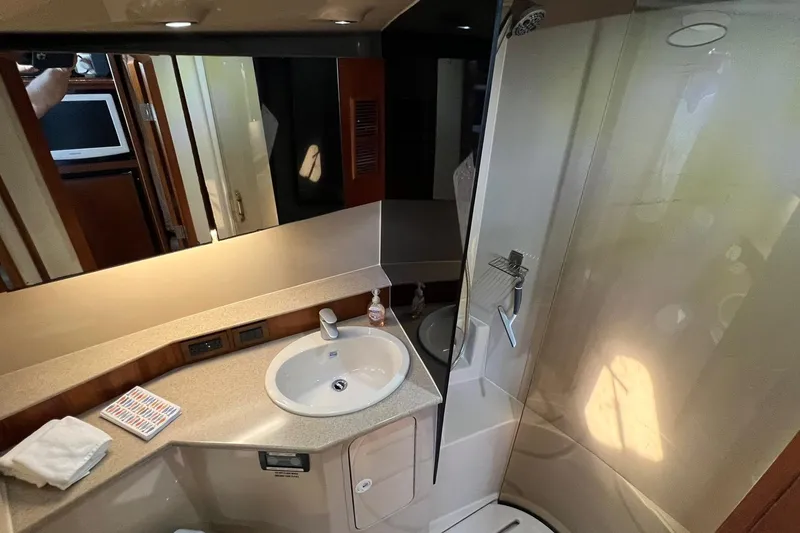 Slide: The Image of 2005 Rampage 38 Express yacht bathroom with sink, mirror, and shower. - 26