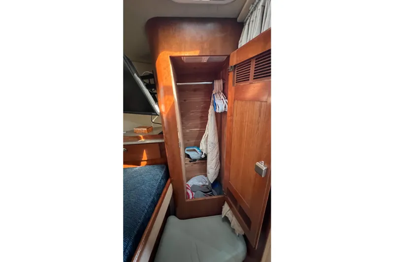 Slide: The Image of 2005 Rampage 38 Express cabin closet with wooden interior and hanging clothes. - 27