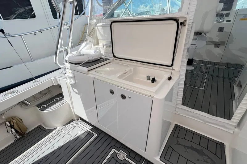 Slide: The Image of 2005 Rampage 38 Express boat interior with sink and storage area. - 33