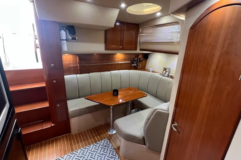 Slide: The Image of Luxurious 2005 Rampage 38 Express yacht interior with elegant wood finishes and cozy seating area. - 36