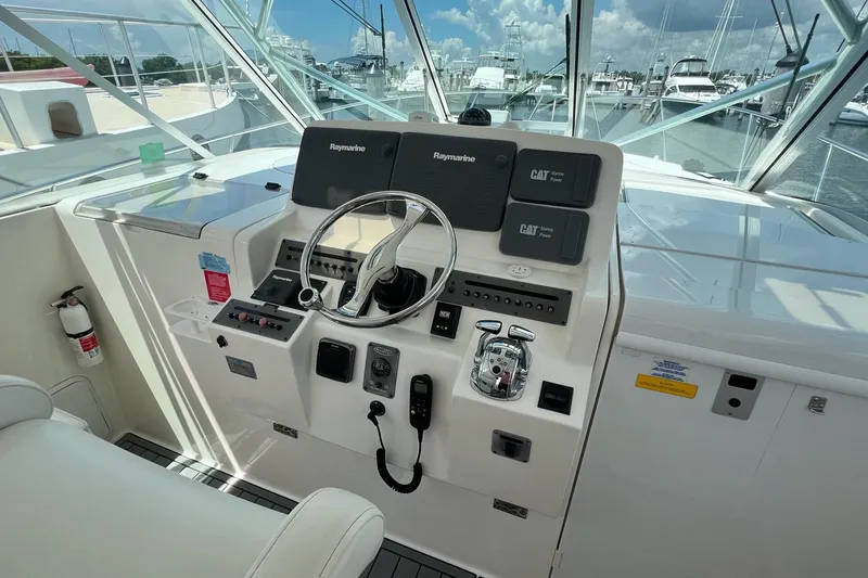 Slide: The Image of Helm of 2005 Rampage 38 Express boat with Raymarine electronics and CAT Marine Power controls. - 4