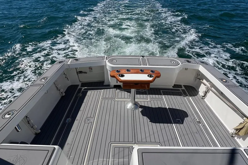 Slide: The Image of 2005 Rampage 38 Express boat deck with ocean view and fishing rod holders. - 5