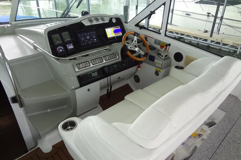 Slide: The Image of Luxurious white seating on 2010 Formula 45 Yacht with wooden flooring and cup holders. - 30