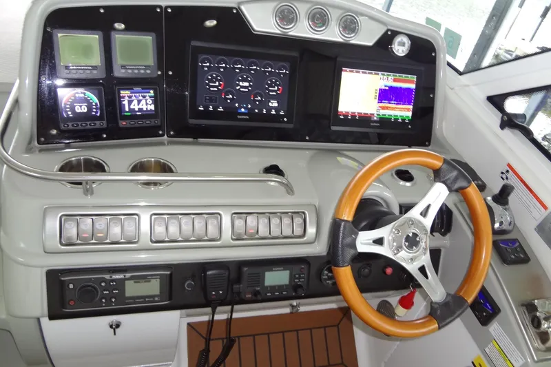 Slide: The Image of Interior seating and table on a 2010 Formula 45 Yacht, featuring white and blue upholstery. - 32