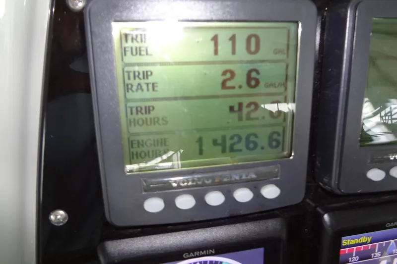 Slide: The Image of 2010 Formula 45 Yacht interior with white seating and a speckled table on teak flooring. - 34