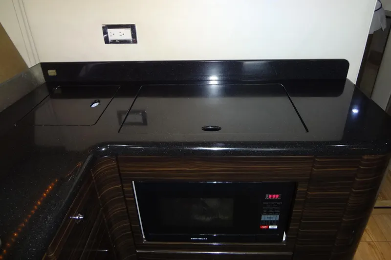 Slide: The Image of Luxurious white seating on 2010 Formula 45 Yacht, featuring sleek design and cup holders. - 42