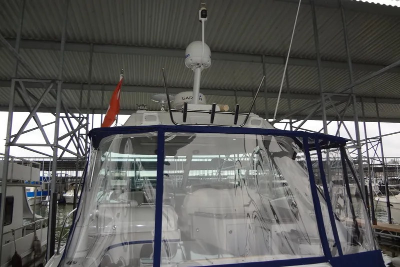 Slide: The Image of 2010 Formula 45 Yacht on water, clear sky, for sale sign visible. - 8