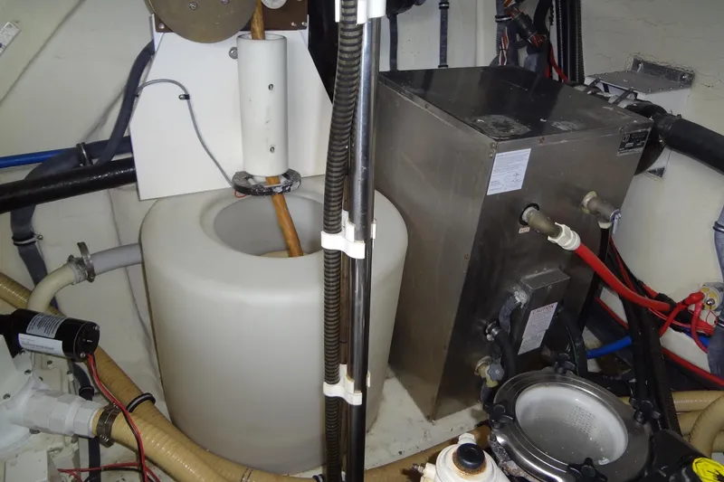 Slide: The Image of Engine room of a 2010 Formula 45 Yacht with various mechanical components and hoses. - 83