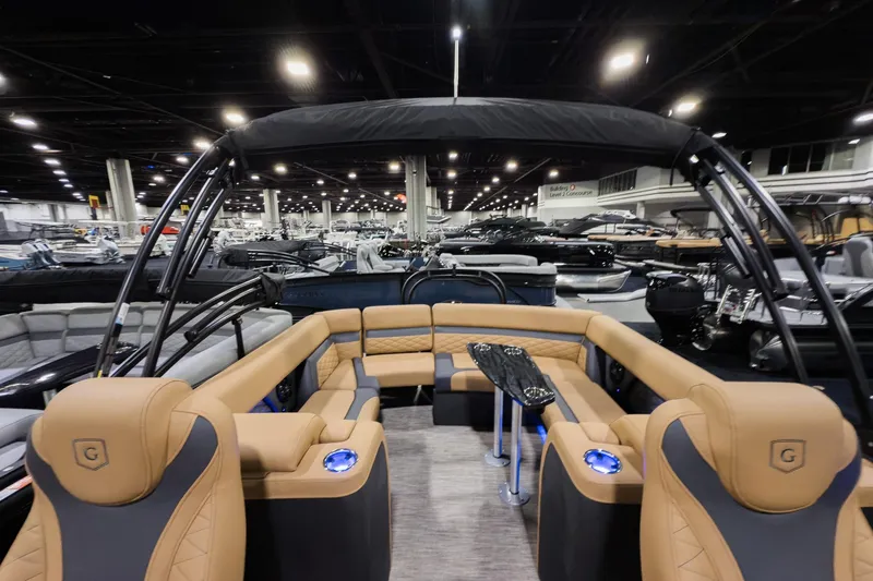 Slide: The Image of 2026 Godfrey Monaco 235 Ultra Lounge boat interior at a showroom, featuring luxurious seating. - 17